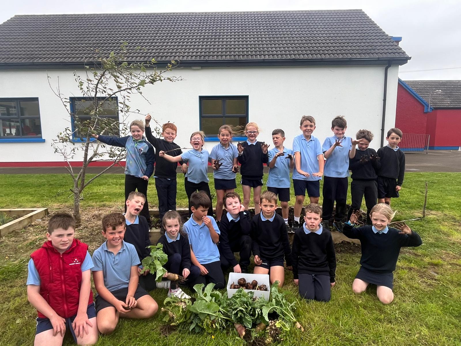 Ms. Cusack’s class with vegetables harvested from the school garden